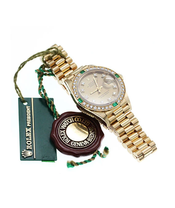 Rolex 69078G Datejust 26mm Champagne Dial in 18k Yellow Gold with Emerald and Diamonds Womens Watch